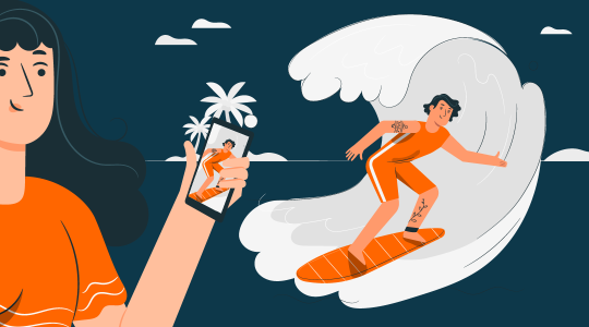 Eine Touristin fotografiert am Palmenstrand einen Surfer, der auf einer Welle reitet. Beim Roaming im Ausland gilt es einiges zu beachten, damit das Surfen im Internet nicht zur Kostenfalle wird.